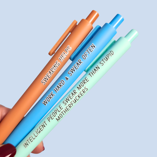 Three pens with sayings on them. "Swearing Helps"(Caramel  pen), "Work Hard & Swear often" (bright blue pen), "Intelligent people swear more than stupid motherfuckers" ( mint pen)