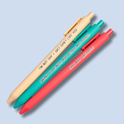 Three pens with sayings on them. "I'm not shy, I just don't like you"(linen pen), "I want to be nice, but people are stupid" (teal pen), "Cute but unstable" ( salmon pink pen).