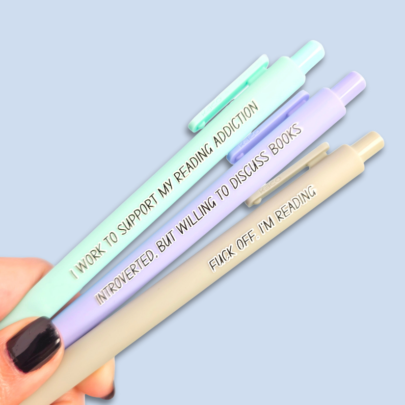 Three pens with humorous text on a light blue background