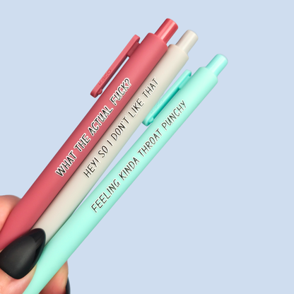 Three pens with sayings on them. "What the actual fuck?."(dust pink pen), "Hey! So I don't like that" (Light grey pen), "Feeling kinda throat punchy" ( mint pen).