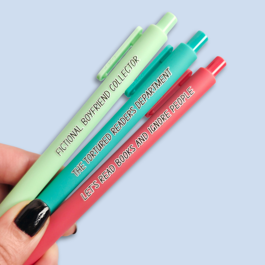 Three pens with sayings on them. "Fictional Boyfriend Collector"(light green pen), "The Tortured Readers Department" (teal pen), "Let's read books and ignore people" ( salmon pink pen).