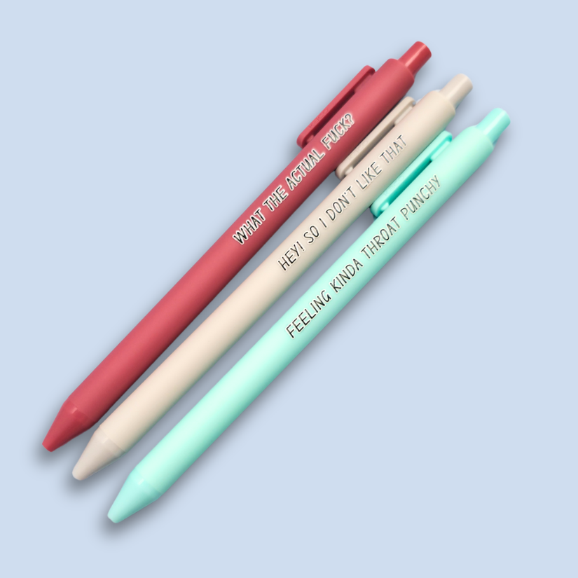 Three pens with sayings on them. "What the actual fuck?."(dust pink pen), "Hey! So I don't like that" (Light grey pen), "Feeling kinda throat punchy" ( mint pen).
