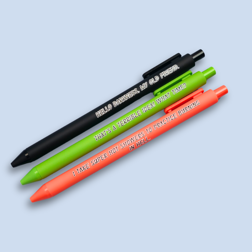 Three pens with quotes. "Hello darkness, my old friend." on a black pen, ' That's a terrible idea. What time?" on a lime green pen, and "I take super hot showers to practice burning in hell" on a orange pen.