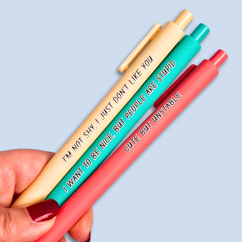 Three pens with sayings on them. "I'm not shy, I just don't like you"(linen pen), "I want to be nice, but people are stupid" (teal pen), "Cute but unstable" ( salmon pink pen).