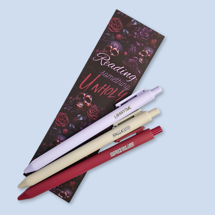 Three pens with sayings on them. "LAHWYTMC"(lavender pen), "BAGGACOTD" (grey pen), "STFUATTDLAGG" ( dark red pen).