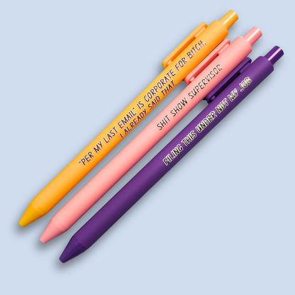 Three pens with sayings on them. "Per My Last Email" is Corporate for bitch, I already said that."(bright yellow pen), "Shit show supervisor" (pastel Pink pen), "Filing this under not my job" ( purple pen).
