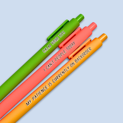 Three colorful pens with humorous text on a light blue background