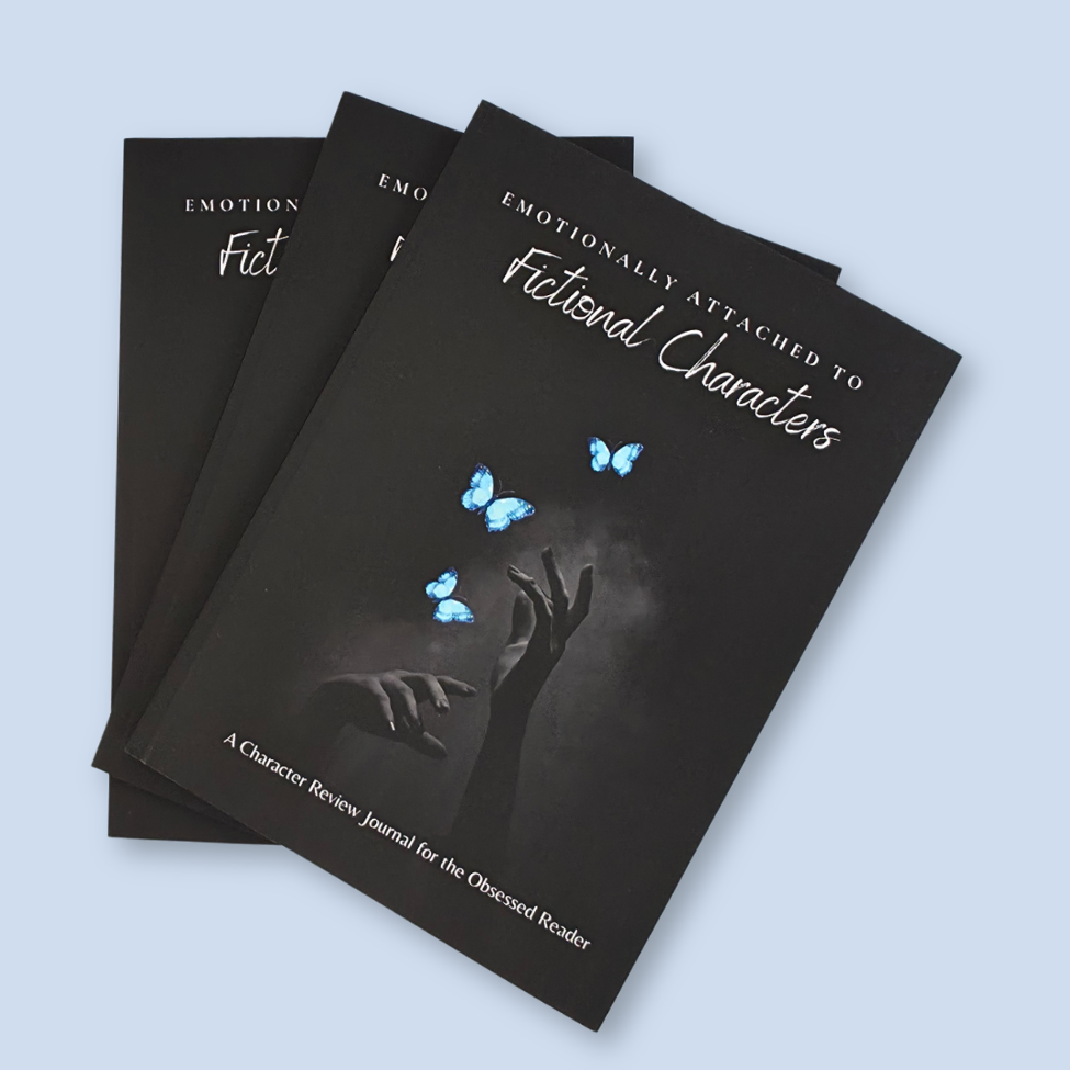 Three copies of a black journal titled 'Emotionally Attached to Fictional Characters' fanned out on a light blue background. The cover features white script text and an illustration of a hand reaching up toward blue butterflies.