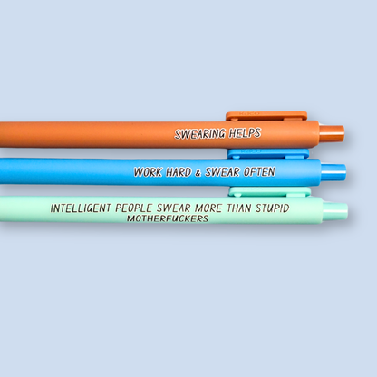 Three pens with sayings on them. "Swearing Helps"(Caramel  pen), "Work Hard & Swear often" (bright blue pen), "Intelligent people swear more than stupid motherfuckers" ( mint pen)