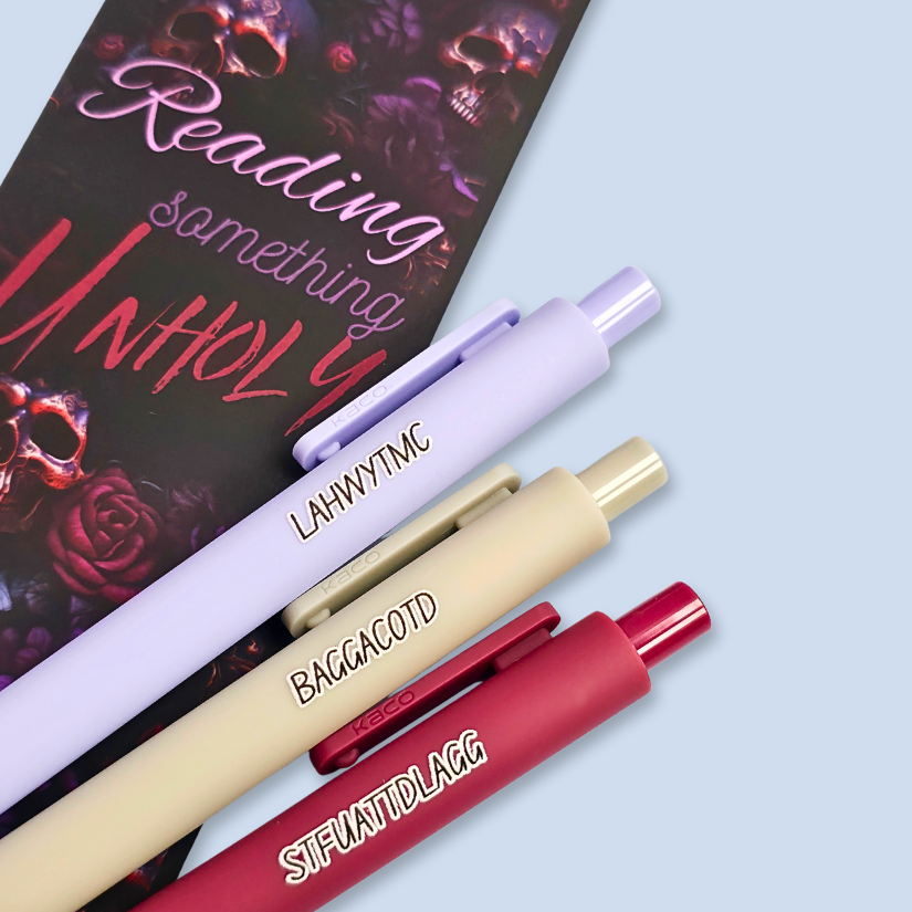 Three pens with sayings on them. "LAHWYTMC"(lavender pen), "BAGGACOTD" (grey pen), "STFUATTDLAGG" ( dark red pen).