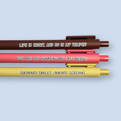 Three pens with humorous text on a light blue background. Text reads, "Life is short, and so is my temper" on a brown pen, "You are dry humping my last nerve" on a pink pen and "Outward smiles, inward screams" on a olive green pen