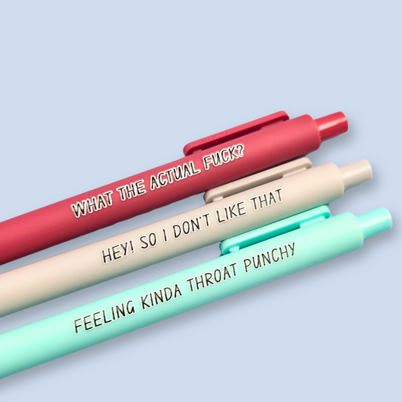 Three pens with sayings on them. "What the actual fuck?."(dust pink pen), "Hey! So I don't like that" (Light grey pen), "Feeling kinda throat punchy" ( mint pen).