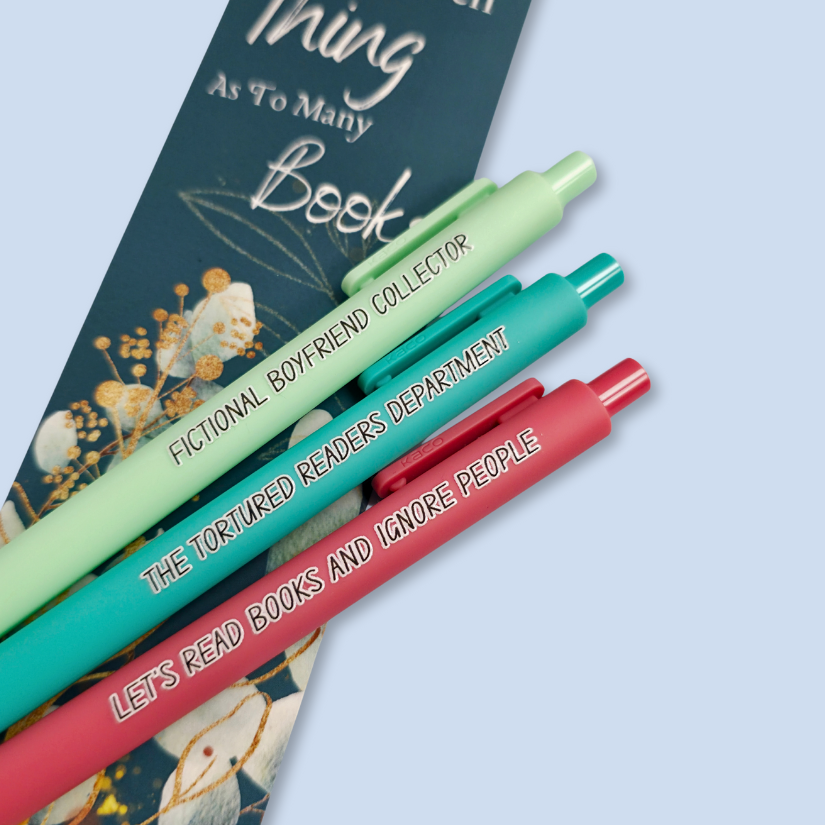 Three pens with sayings on them. "Fictional Boyfriend Collector"(light green pen), "The Tortured Readers Department" (teal pen), "Let's read books and ignore people" ( salmon pink pen).
