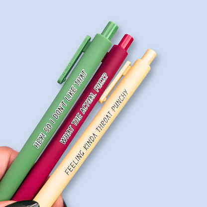 Three pens with sayings on them. "What the actual fuck?."(wine pen), "Hey! So I don't like that" (moss green pen), "Feeling kinda throat punchy" ( linen pen).