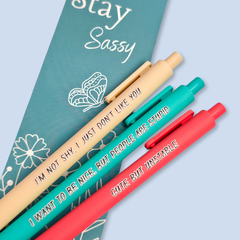 Three pens with sayings on them. "I'm not shy, I just don't like you"(linen pen), "I want to be nice, but people are stupid" (teal pen), "Cute but unstable" ( salmon pink pen).
