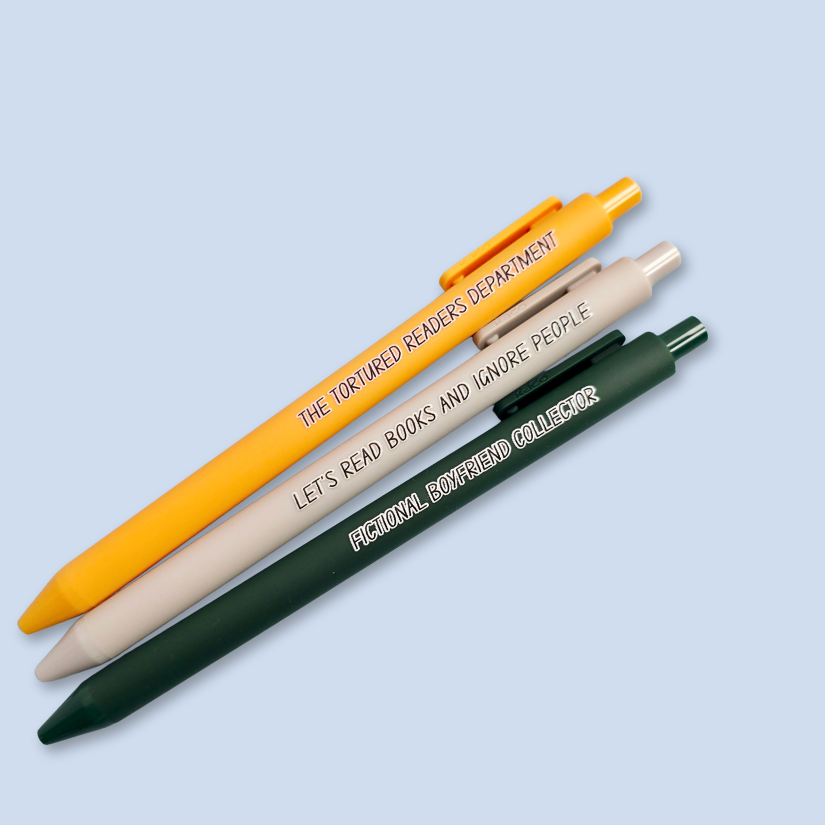 Three pens with sayings on them. "Fictional Boyfriend Collector"(forest green pen), "The Tortured Readers Department" (bright yellow pen), "Let's read books and ignore people" ( light grey pen).