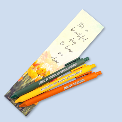 Three pens with humorous text on a light blue background