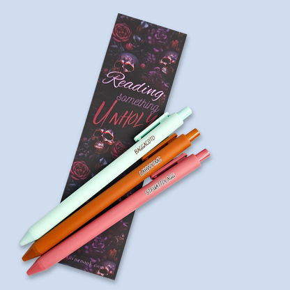 Three pens with sayings on them. "LAHWYTMC"(sienna pen), "BAGGACOTD" (mint pen), "STFUATTDLAGG" ( dust rose pen).