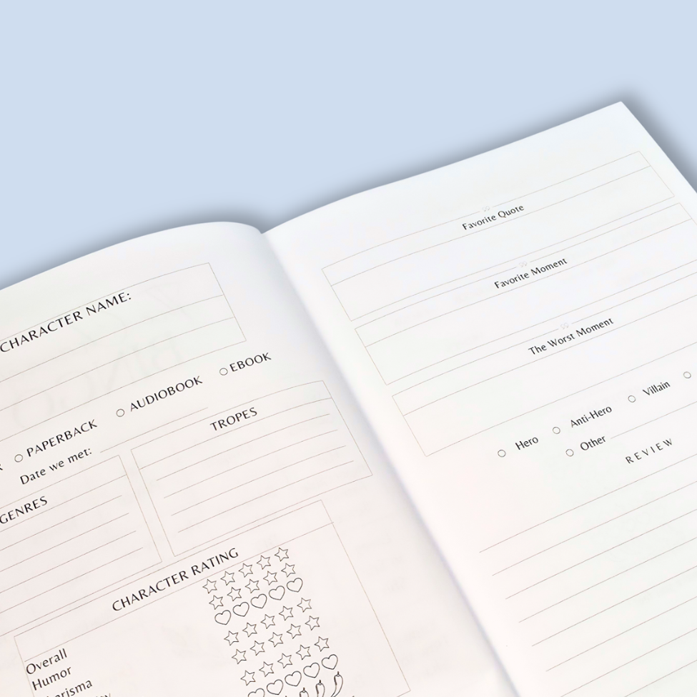An open planner or notebook showing printed character and review fields on both pages, photographed on a pale blue background.
