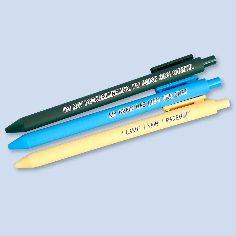 Three pens with humorous text on a light blue background