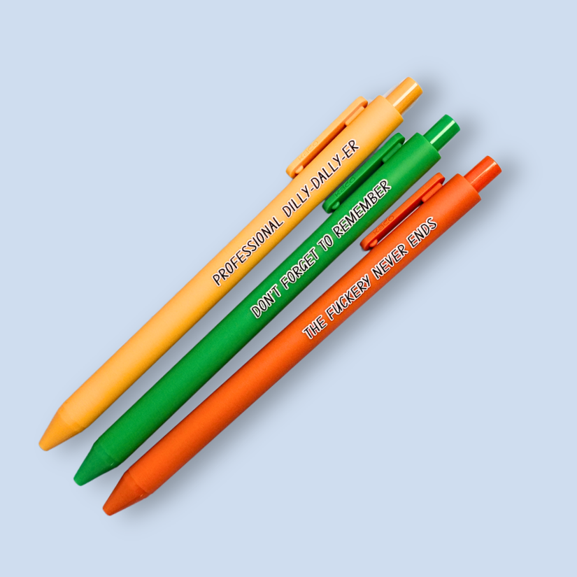 Three pens with humorous text on a light blue background. Text reads, "Professional Dilly-Dally-Er" on a yellow pen, "Don't forget to remember" on a green pen and "The fuckery never ends" on a orange pen