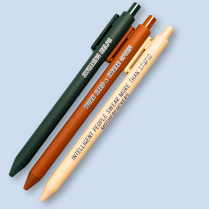 Three pens with sayings on them. "Swearing Helps"(forest green  pen), "Work Hard & Swear often" (sienna pen), "Intelligent people swear more than stupid motherfuckers" ( linen pen). 
