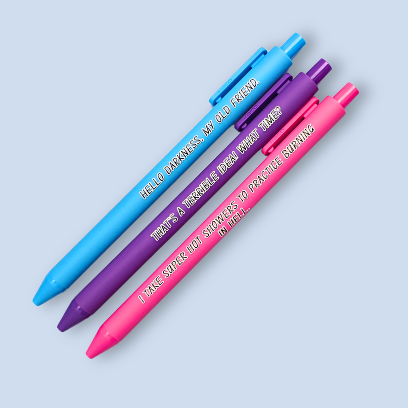Three pens with quotes. "Hello darkness, my old friend." on a bright blue pen, ' That's a terrible idea. What time?" on a purple pen, and "I take super hot showers to practice burning in hell" on a hot pink pen.