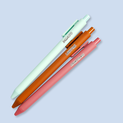 Three pens with sayings on them. "LAHWYTMC"(sienna pen), "BAGGACOTD" (mint pen), "STFUATTDLAGG" ( dust rose pen).