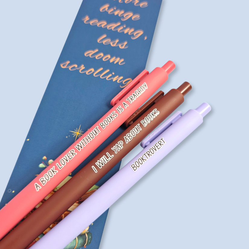 Three pens with book-themed text on a blue background
