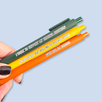 Three pens with humorous text on a light blue background