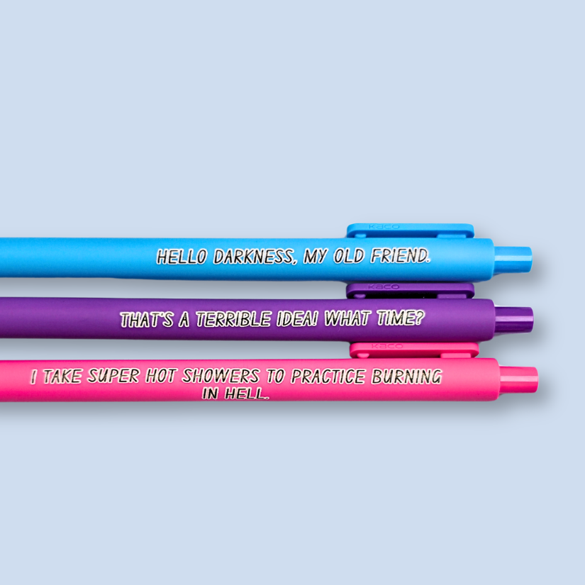 Three pens with quotes. "Hello darkness, my old friend." on a bright blue pen, ' That's a terrible idea. What time?" on a purple pen, and "I take super hot showers to practice burning in hell" on a hot pink pen.