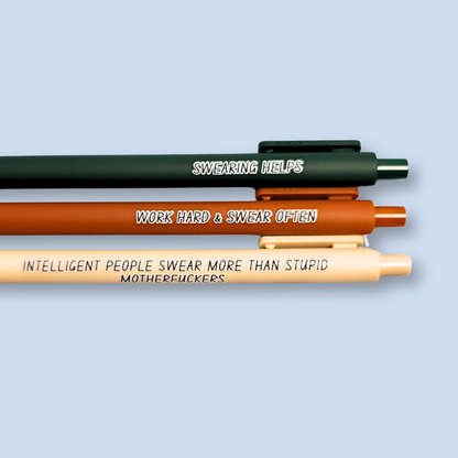 Three pens with sayings on them. "Swearing Helps"(forest green  pen), "Work Hard & Swear often" (sienna pen), "Intelligent people swear more than stupid motherfuckers" ( linen pen). 
