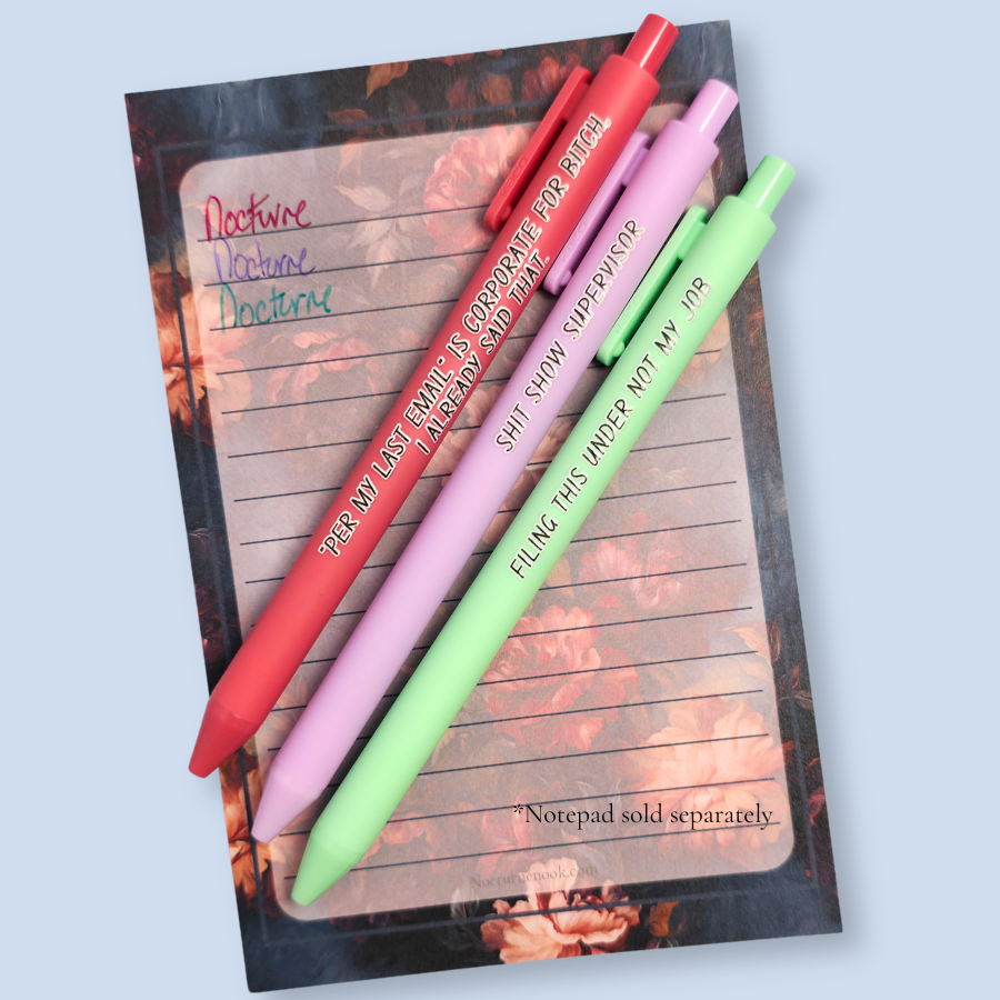 Three pens with sayings on them. "Per My Last Email" is Corporate for bitch, I already said that."(salmon pink pen), "Shit show supervisor" (lilac pen), "Filing this under not my job" ( pastel green pen). Ink matches the color of the pen